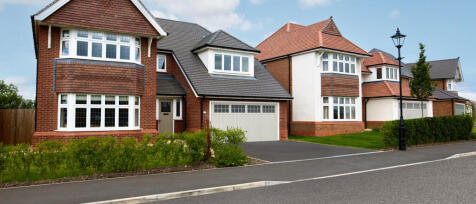 Modern detached houses with bay windows, red and white exteriors, and well-maintained front gardens