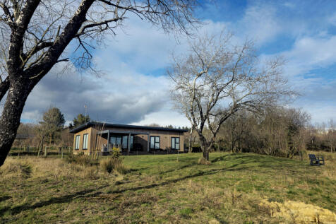 Tranquil setting of an existing holiday lodge abov