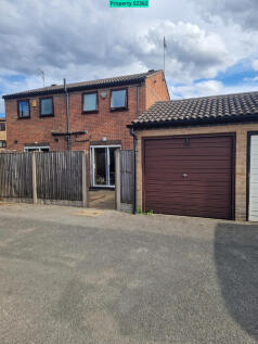 Garage at rear of house and gate into patio