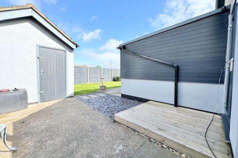 Outbuilding, patio and decking