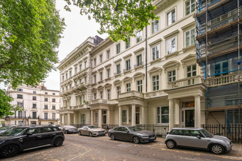 White Stucco Fronted Building with Residents Parking