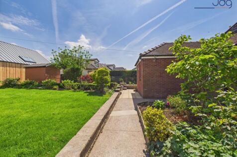 Mature gardens that extend to the front of the driveway