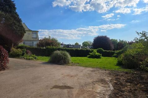 The front garden is situated adjacent to the driveway.