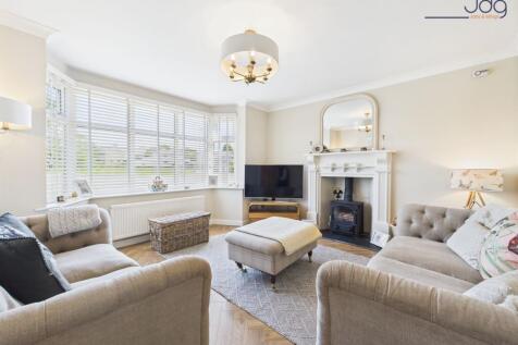 Cosy bay-fronted lounge with multi-fuel stove