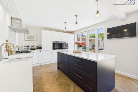 Shaker-style kitchen with integrated appliances and twin sets of French Doors