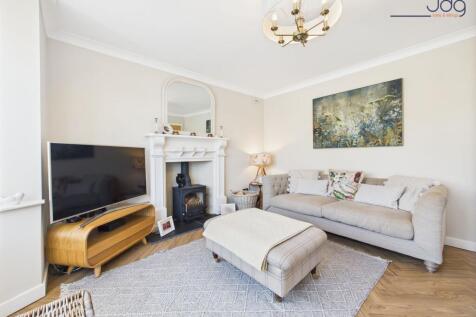 Cosy bay-fronted lounge with multi-fuel stove