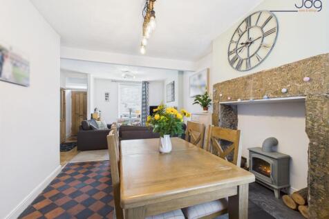 Spacious open-plan lounge diner and decorative fireplace with electric stove