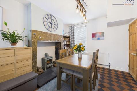 Spacious open-plan lounge diner and decorative fireplace with electric stove