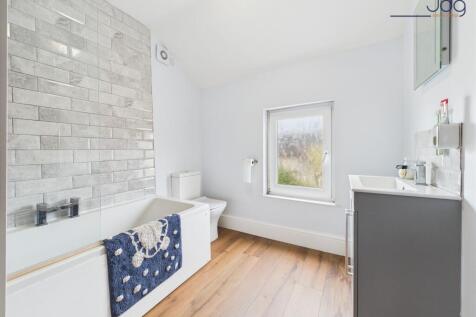 Modern three-piece suite and wood-effect vinyl flooring