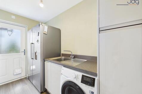 Separate utility room mirrors the kitchen units and gives internal access to the garage