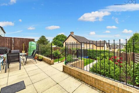 Tiered with steps up from the patio to a raised lawn