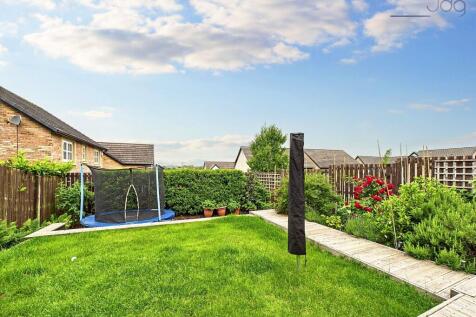 Tiered with steps up from the patio to a raised lawn