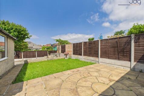 Generously sized garden with a patio and lawn