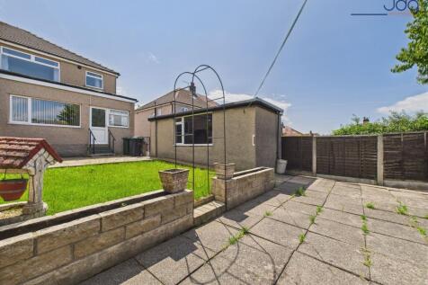 Generously sized garden with a patio and lawn