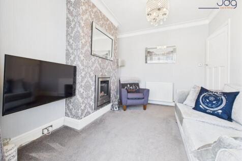 Lounge with bay window and a modern feature fireplace