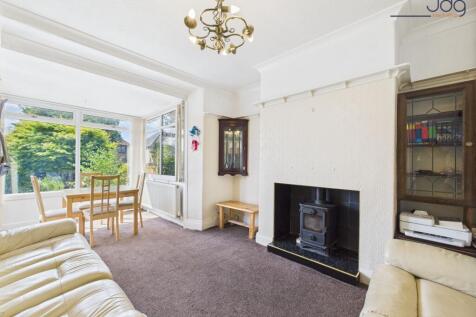 Living Room with extended sunroom and wood-burning stove