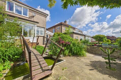 South-facing rear garden with bridge and small pond