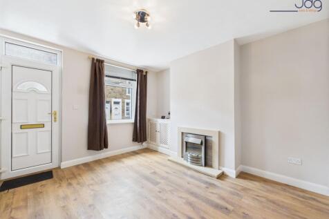 Lounge with wood-effect flooring and electric fire