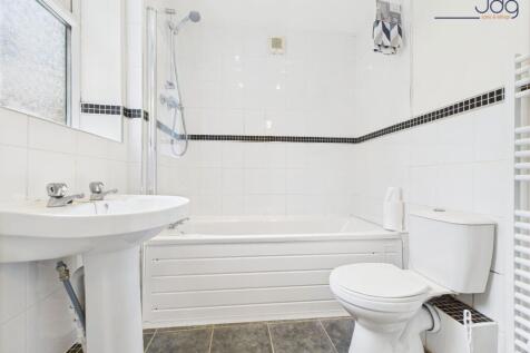 Fully tiled ground floor bathroom with overhead shower