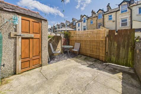 Low-maintenance rear yard with bamboo screening for privacy