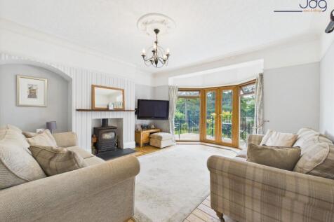 Cosy Lounge with River Views and Log Burner