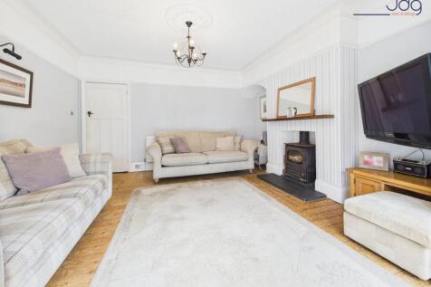 Cosy Lounge with River Views and Log Burner
