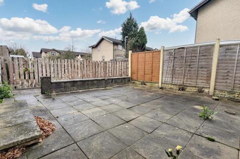 Flagged garden that wraps around the rear of the property