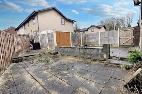 Flagged garden that wraps around the rear of the property