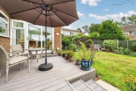 Rear Garden with Decked Seating Area and Lawn with mature plants