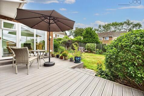 Rear Garden with Decked Seating Area and Lawn with mature plants