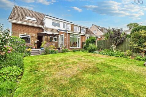 Rear Garden with Decked Seating Area and Lawn with mature plants