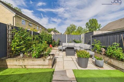 Beautifully Landscaped Garden with mixture of flags and artificial grass