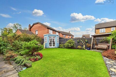 Northwest Garden with summer house and a mixture of lawn and flags