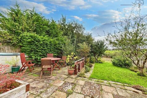 South West facing garden with prize winning pear tree, flags and lawn