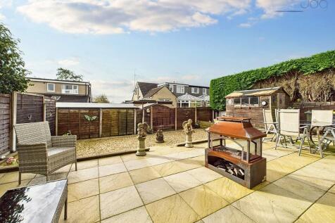 Garden featuring patio, gravel section, shed, and outdoor tap
