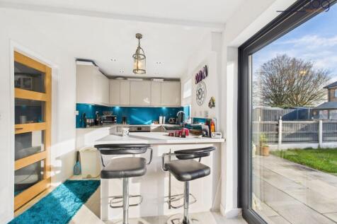 Open Plan Kitchen Diner with Breakfast Bar and bi-folding doors