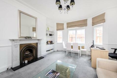 High ceilings &amp; period fireplace in reception room