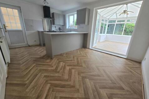 Dining area into kitchen and conservatory
