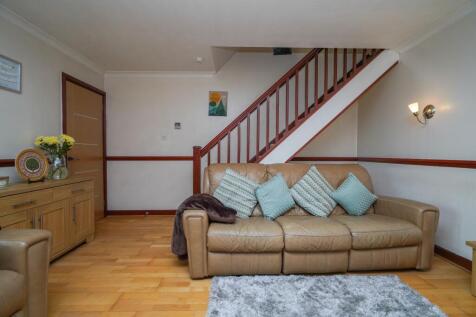 Spacious Living Room with Door Leading to Entry Vestibule