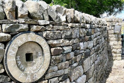 The Stone Wall By The Gated Entrance