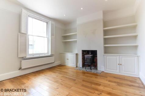 Living room to the front with a wooden floor