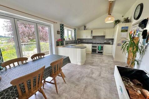 Open plan kitchen diner with doors to...