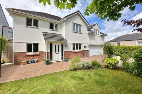 Front with brick paved drive and encl...