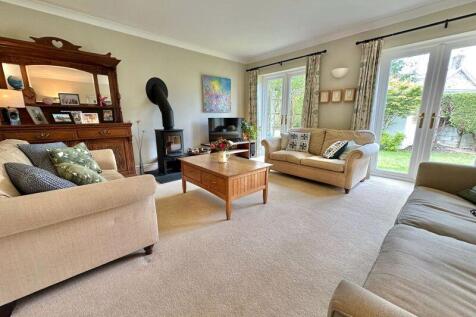 Living room with log burner and doors...