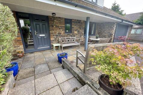 Attractive covered entrance and natur...