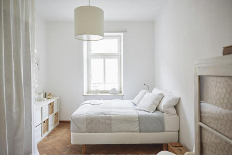 white-coloured-bedroom-with-parquet-floor-bed-and-