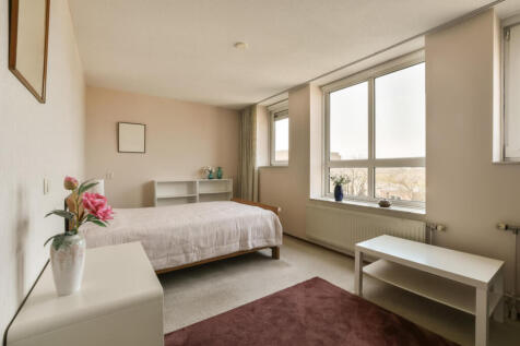 a-bedroom-with-a-bed-and-a-table-and-a-2025-02-10-