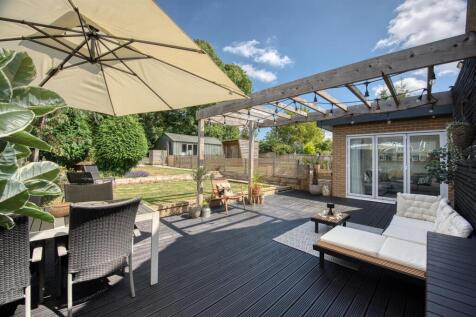 Garden - decking and pergola towards bifold doors.