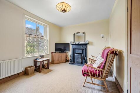 Sitting Room to fireplace and window.jpg