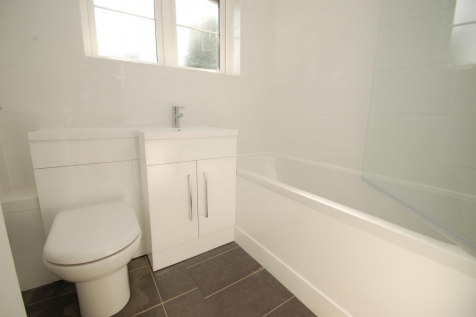 Bright White Bathroom with Modern Fixtures.png
